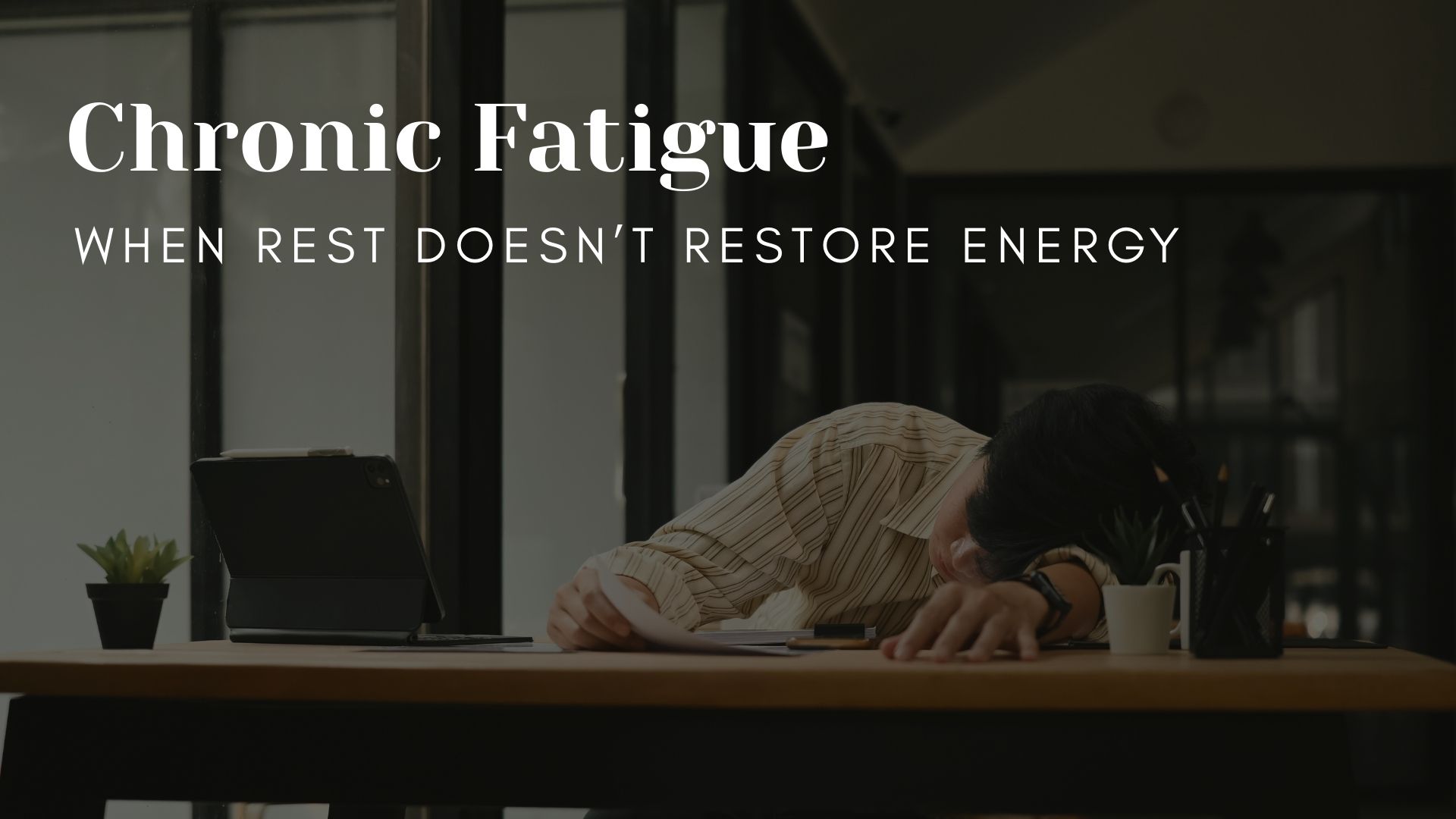 chronic-fatigue-when-rest-doesnt-restore-energy Person resting at a desk with head down, representing chronic fatigue where rest does not restore energy