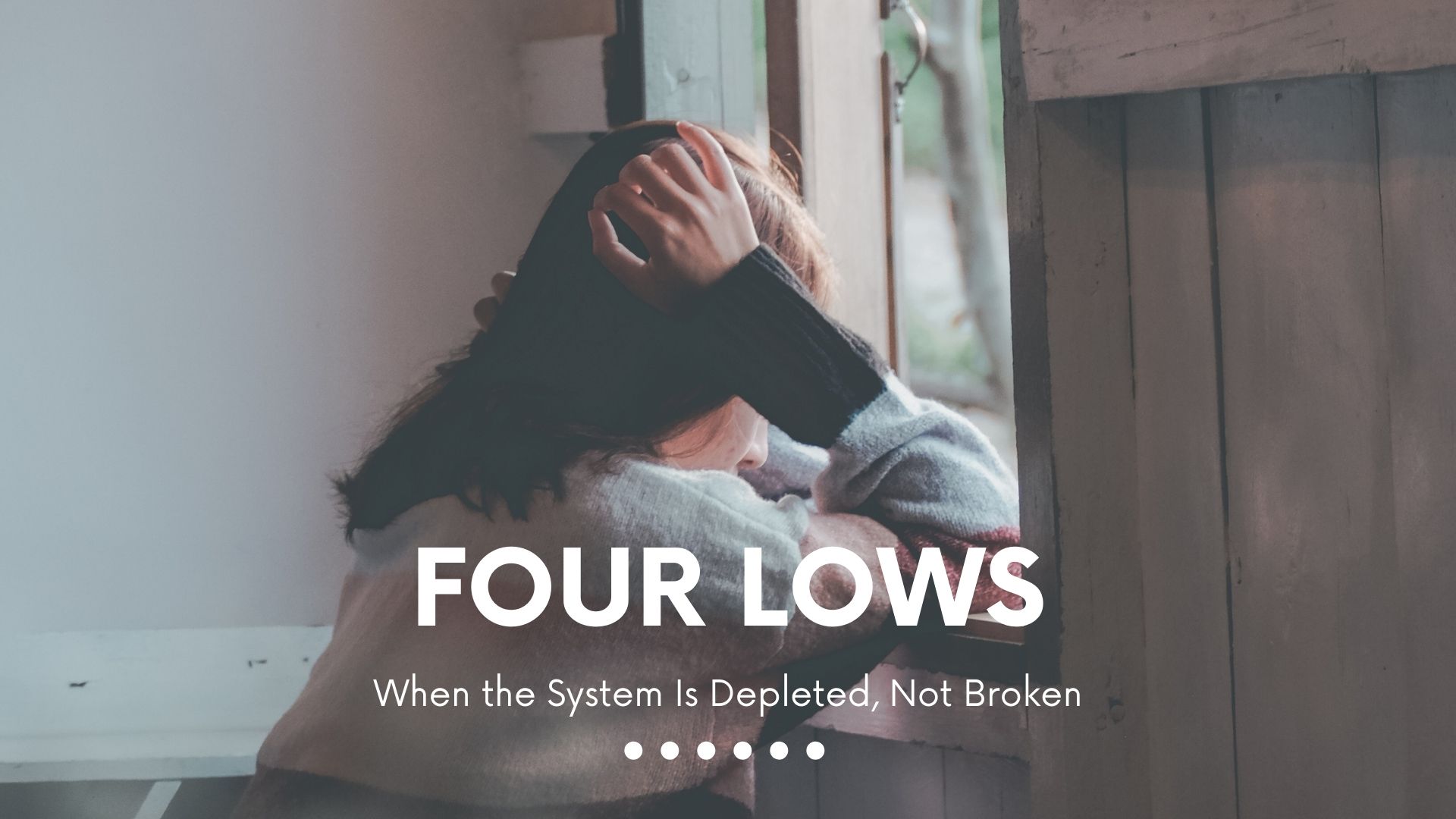 four-lows-htma-mineral-depletion-adrenal-thyroid-exhaustion.jpg Person sitting by a window holding their head, illustrating the Four Lows pattern in HTMA, a state of mineral depletion and low adrenal and thyroid activity rather than disease.