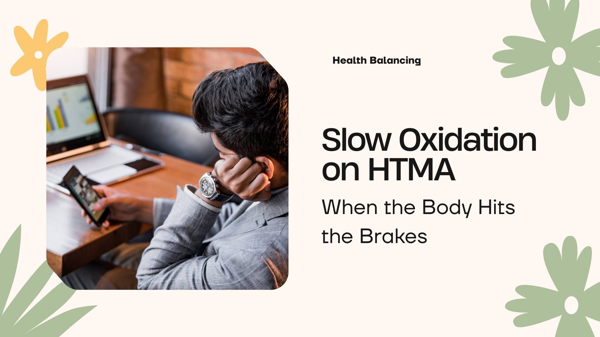 Man sitting at a desk looking fatigued while using a phone and laptop, representing slow oxidation on HTMA and the body slowing down due to metabolic stress.