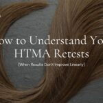 Close-up of strands of brown hair arranged in loops on a textured surface, representing a hair tissue mineral analysis (HTMA) test concept